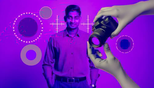 Image of a person operating a camera to focus the man in the video to ensure high quality production.